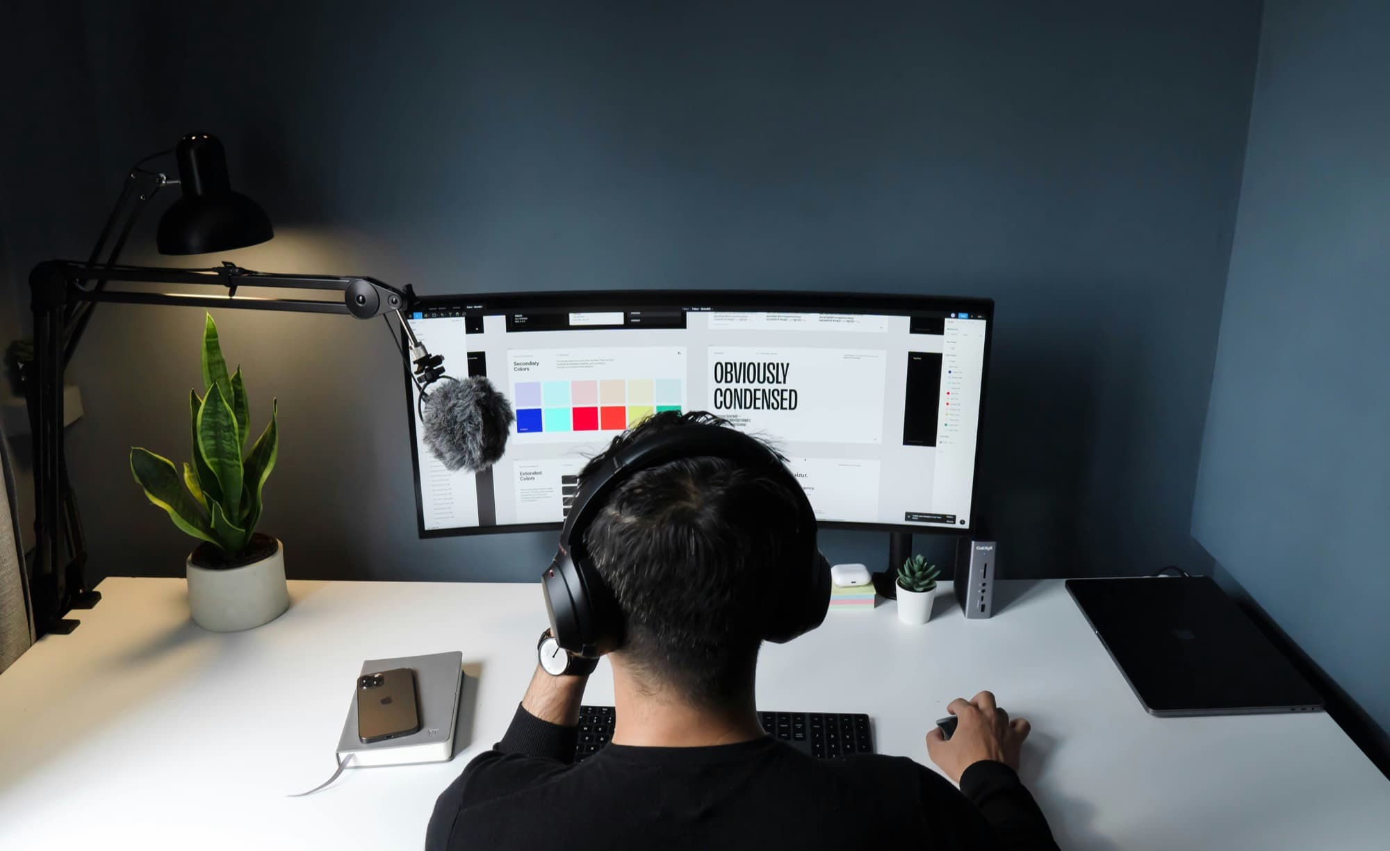 A designer working on a brand layout at a large monitor